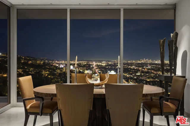 a view of a chairs and table in the balcony