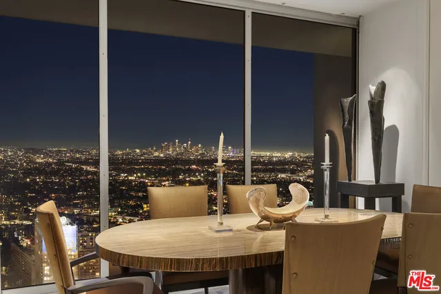 a dining room with furniture and a floor to ceiling window