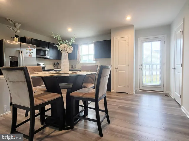a view of a dining room with furniture window and wooden floor
