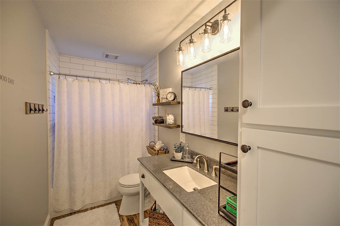 98 Ridgeway Drive Decatur, IL 62521 - Photo 15 of 31 a bathroom with a double vanity sink toilet and a mirror