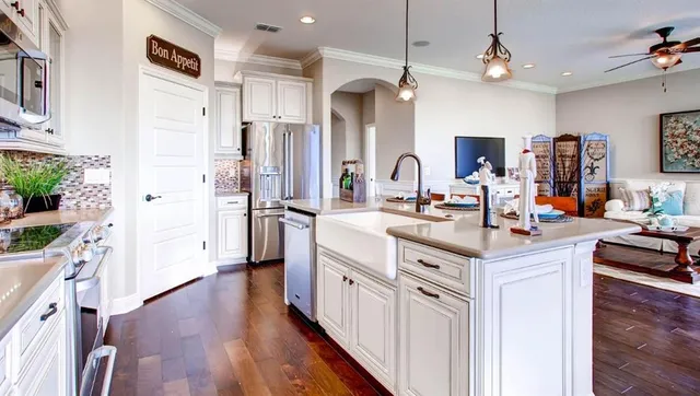 a kitchen with stainless steel appliances a sink stove and refrigerator