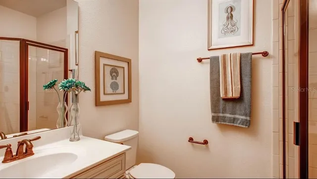 a bathroom with a sink toilet and mirror