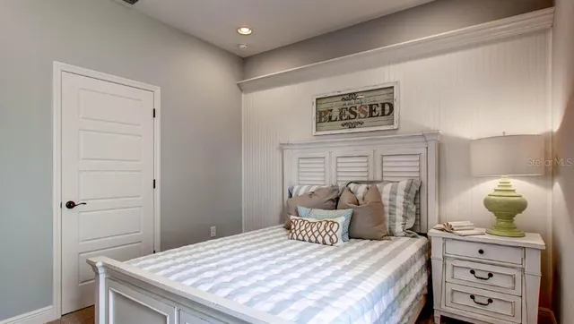 a bedroom with a bed and cabinet