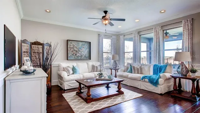 a living room with furniture a chandelier and a table