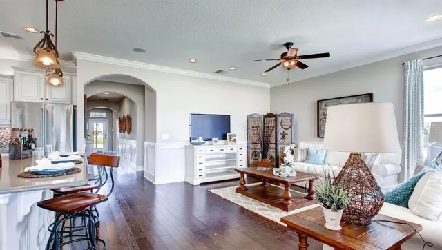 a living room with furniture and wooden floor