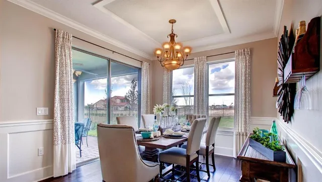 a dining room with furniture garden view and a chandelier