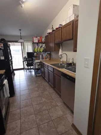 a kitchen with a sink a stove and chairs
