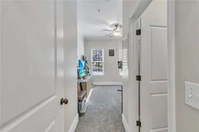 a view of a hallway to a livingroom with furniture
