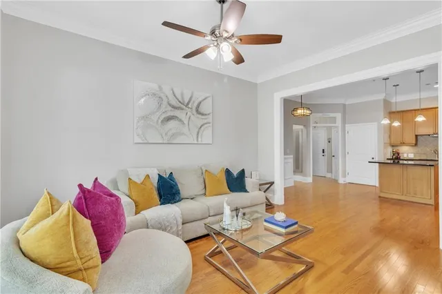 a living room with furniture and a view of kitchen