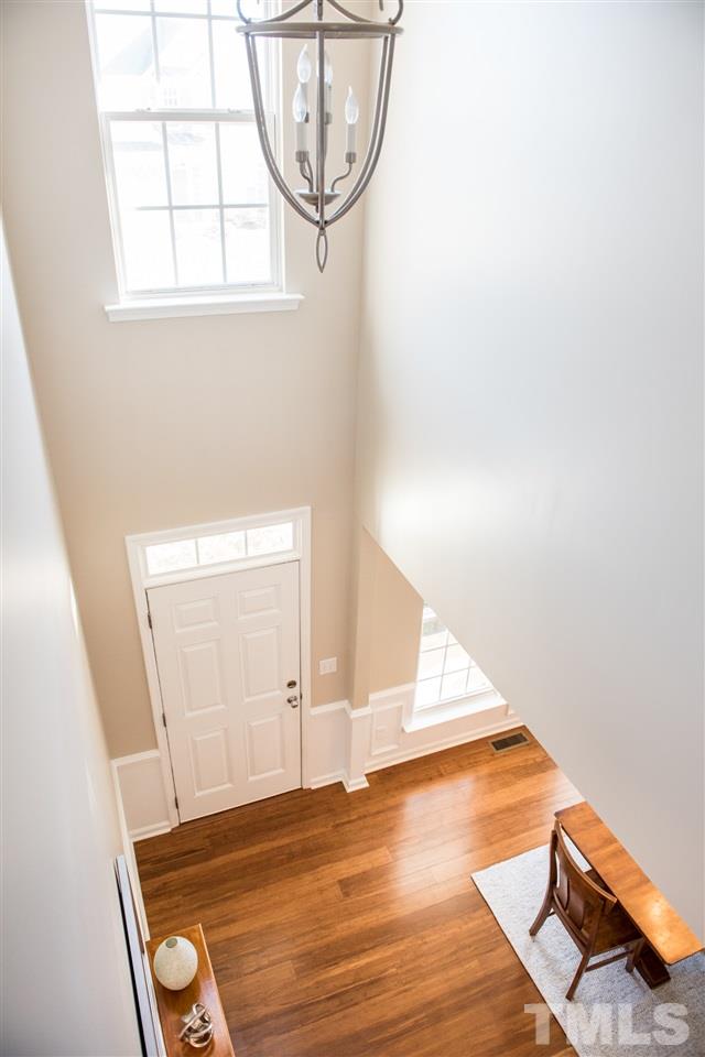 7725 Jackson Dane Drive Raleigh, NC 27613 - Photo 11 of 24 an empty room with wooden floor windows and entryway