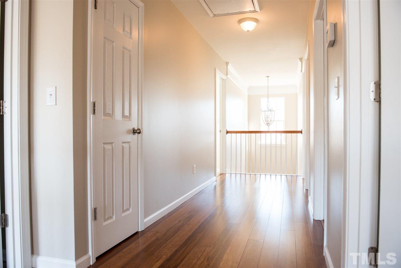 7725 Jackson Dane Drive Raleigh, NC 27613 - Photo 12 of 24 a view of a hallway with wooden floor