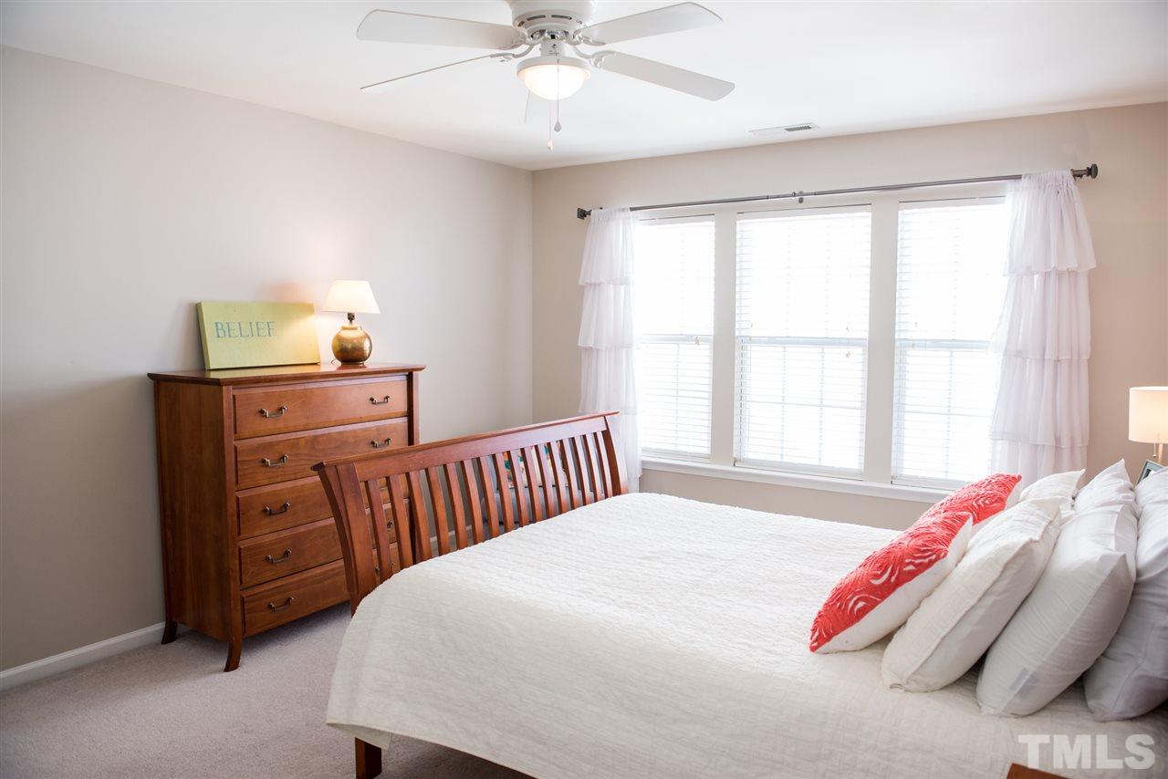 7725 Jackson Dane Drive Raleigh, NC 27613 - Photo 15 of 24 a bedroom with a bed and a window