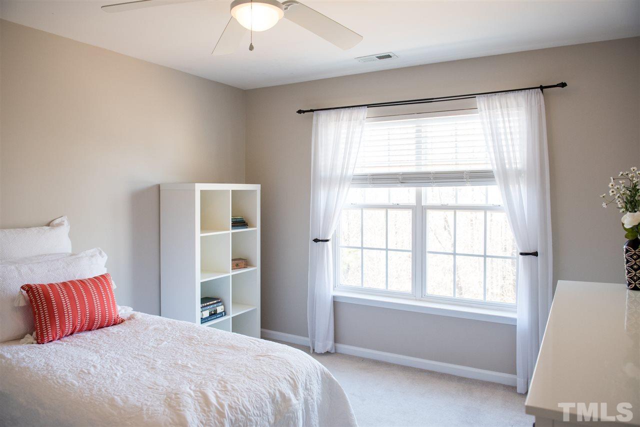 7725 Jackson Dane Drive Raleigh, NC 27613 - Photo 16 of 24 a bedroom with a large bed and a window