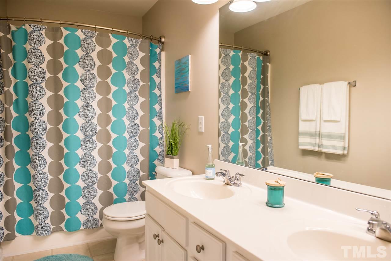 7725 Jackson Dane Drive Raleigh, NC 27613 - Photo 17 of 24 a bathroom with a sink and a mirror