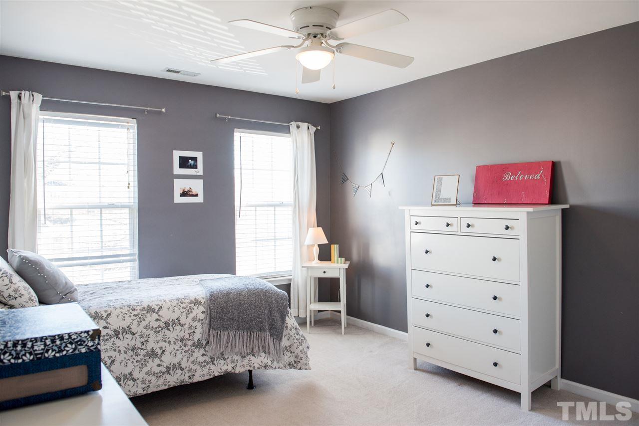 7725 Jackson Dane Drive Raleigh, NC 27613 - Photo 18 of 24 a bedroom with a bed and a dresser