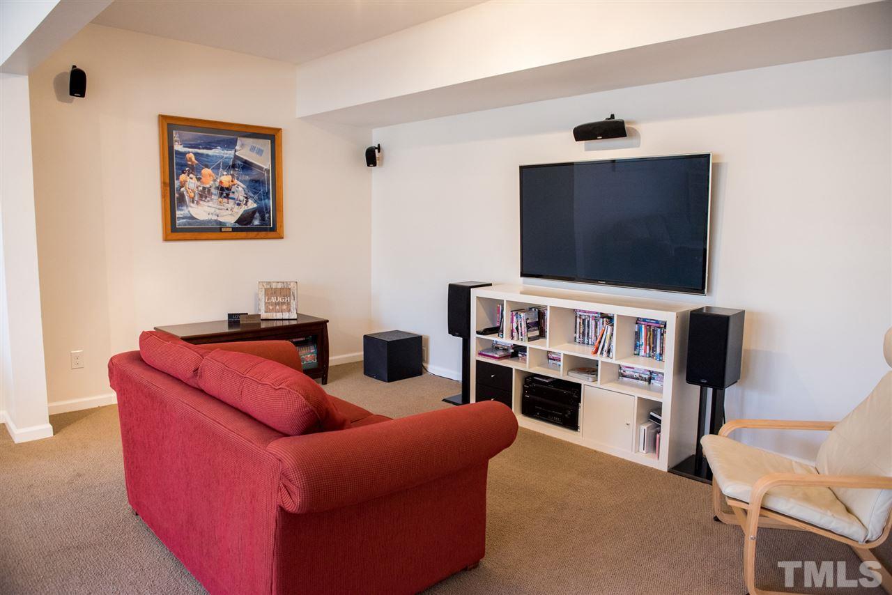 7725 Jackson Dane Drive Raleigh, NC 27613 - Photo 20 of 24 a living room with furniture and a flat screen tv
