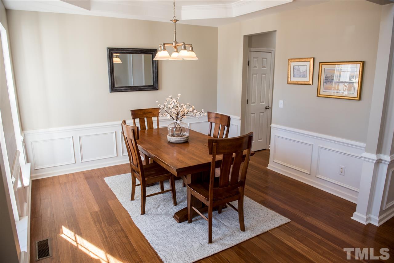 7725 Jackson Dane Drive Raleigh, NC 27613 - Photo 3 of 24 a view of a dining room with furniture and wooden floor