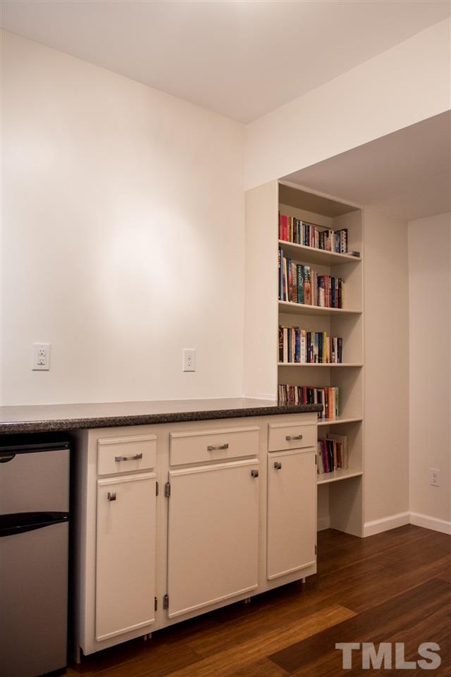 7725 Jackson Dane Drive Raleigh, NC 27613 - Photo 21 of 24 a view of cabinets with wooden floor