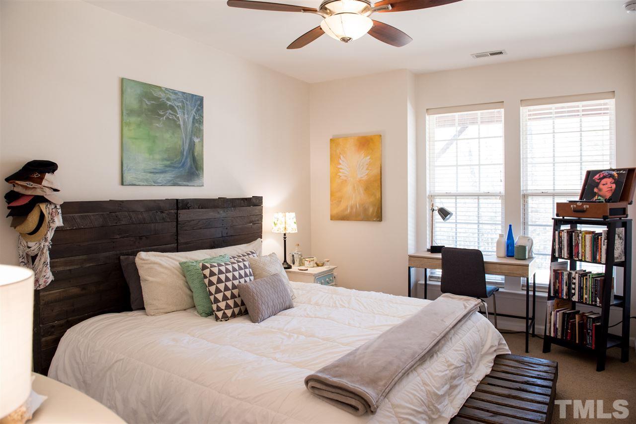 7725 Jackson Dane Drive Raleigh, NC 27613 - Photo 22 of 24 a bedroom with bed and wooden floor