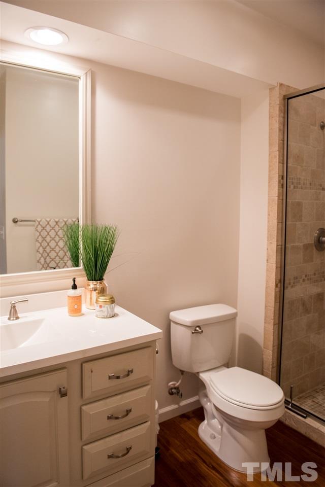 7725 Jackson Dane Drive Raleigh, NC 27613 - Photo 23 of 24 a bathroom with a sink a toilet and shower