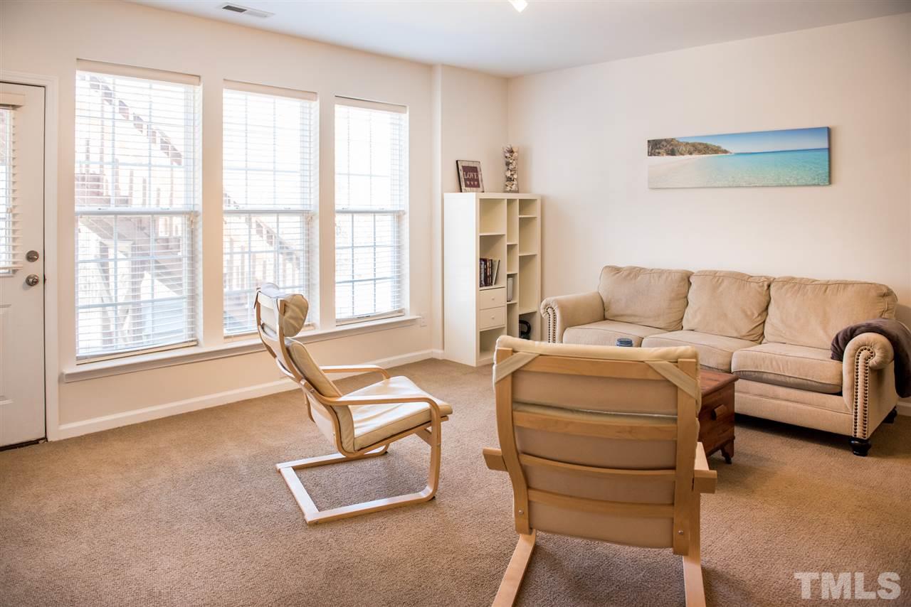 7725 Jackson Dane Drive Raleigh, NC 27613 - Photo 24 of 24 a living room with furniture and floor to ceiling windows