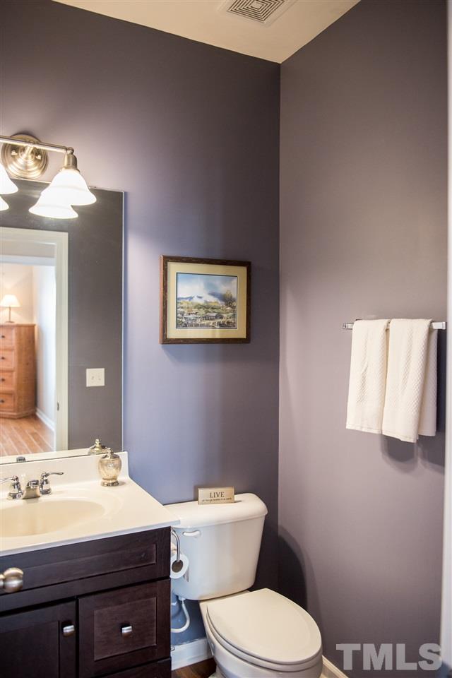 7725 Jackson Dane Drive Raleigh, NC 27613 - Photo 7 of 24 a bathroom with a toilet a sink and mirror