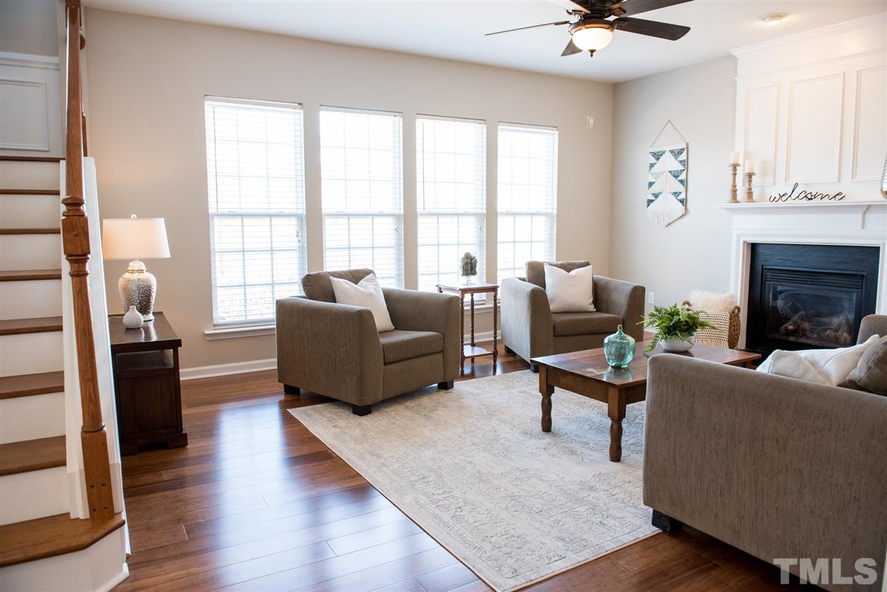 7725 Jackson Dane Drive Raleigh, NC 27613 - Photo 10 of 24 a living room with furniture and a fireplace