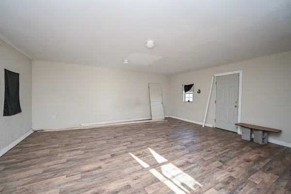 a view of an empty room and wooden floor
