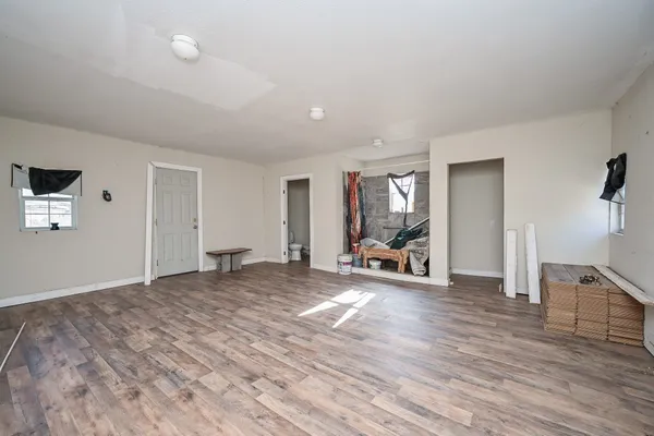 a view of a room with wooden floor and furniture