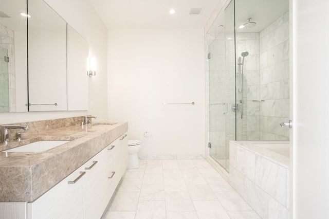 a bathroom with a tub sink and mirror