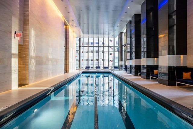 a view of a kitchen with large windows and furniture
