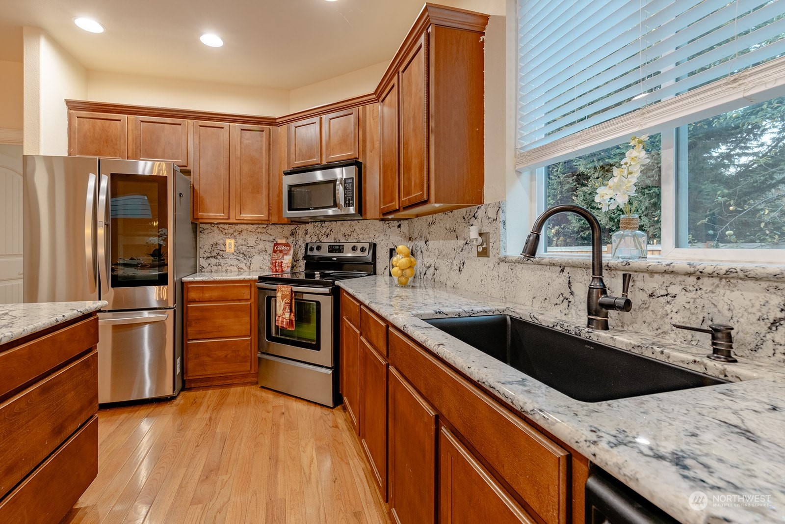 1324 Farina Loop Southeast Olympia, WA 98513 - Photo 11 of 40 a kitchen with stainless steel appliances granite countertop a sink a stove and a refrigerator
