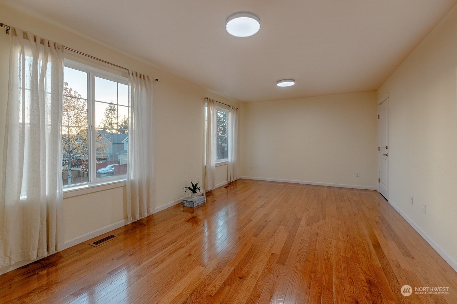 1324 Farina Loop Southeast Olympia, WA 98513 - Photo 15 of 40 an empty room with wooden floor and windows
