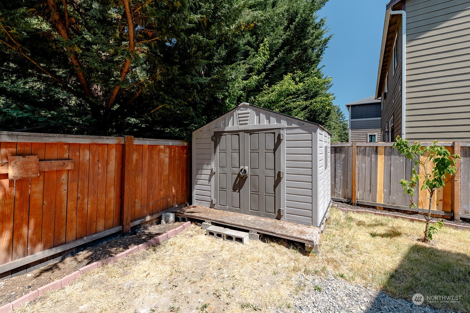 1324 Farina Loop Southeast Olympia, WA 98513 - Photo 35 of 40 a view of a backyard with a small cabin and wooden fence