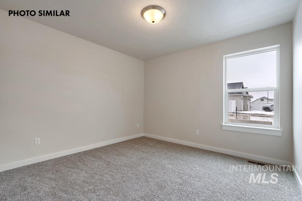 1645 Haystack Emmett, ID 83617 - Photo 27 of 33 Room with neutral wall paint, gray carpet, and a single-pane window with white trim