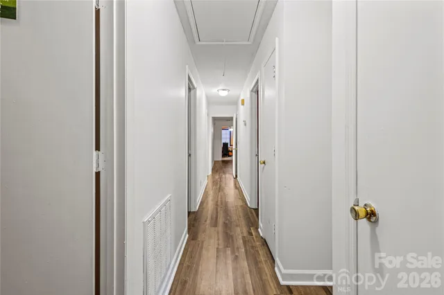 a view of hallway with wooden floor