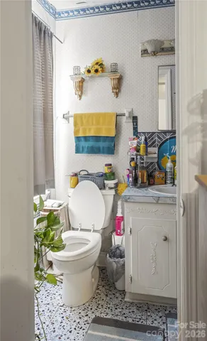 a bathroom with a toilet sink and mirror