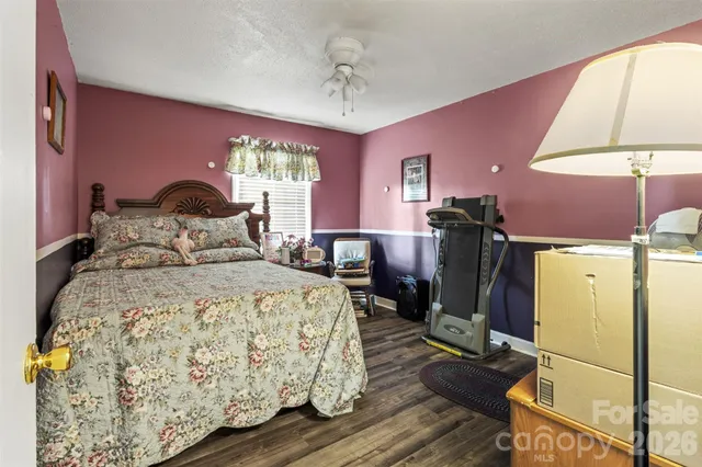 a bedroom with a bed and a lamp