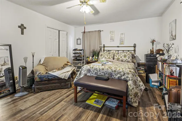 a bedroom with furniture and a wooden floor