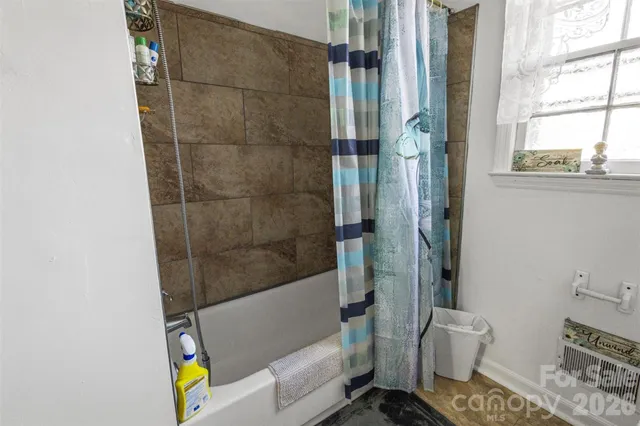 a bathroom with a bathtub and a shower