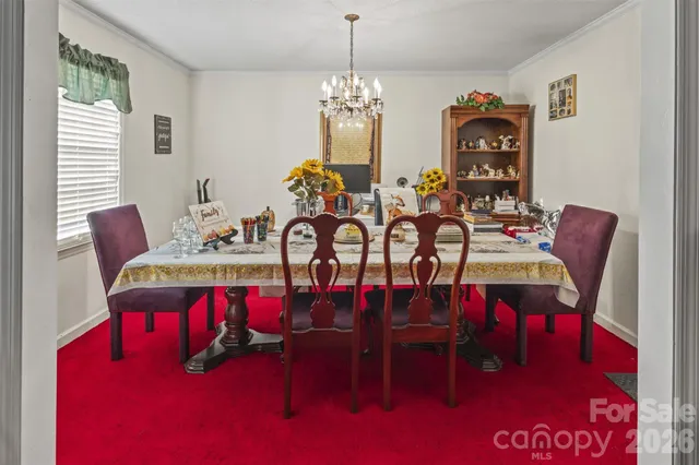 a view of a dining room with furniture and chandelier