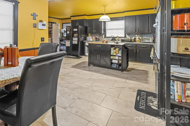 a view of kitchen with stainless steel appliances granite countertop sink and cabinets