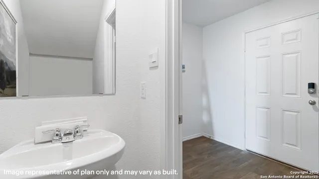 a bedroom with a bed and painting on the wall