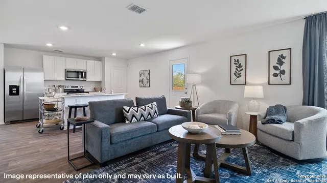 a living room with furniture a lamp and a flat screen tv