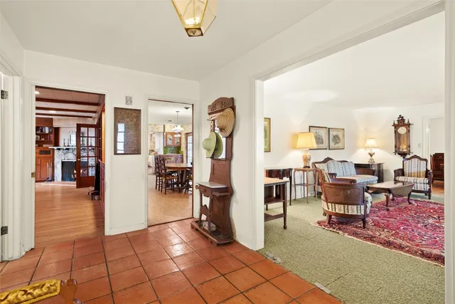a living room with furniture and a dining table