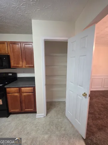 a view of an empty room with a fireplace