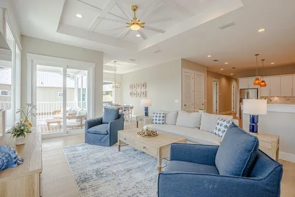 a living room with furniture ceiling fan and a rug