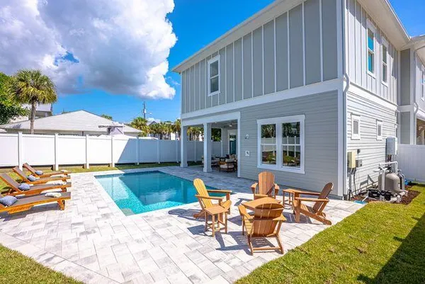 a view of a house with swimming pool and sitting area