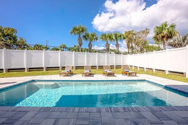 a view of swimming pool with outdoor seating and plants