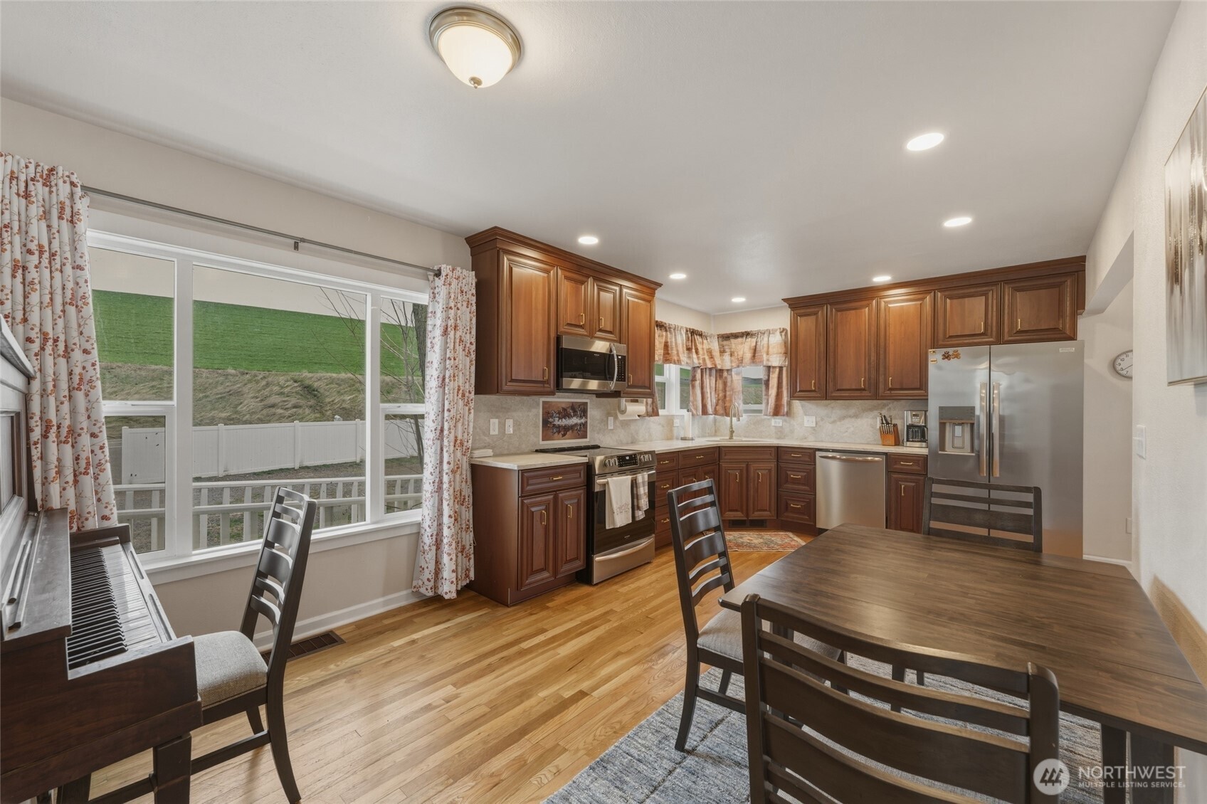 315 Thorn Hollow Road Dayton, WA 99328 - Photo 7 of 40 a kitchen with a table chairs microwave and refrigerator